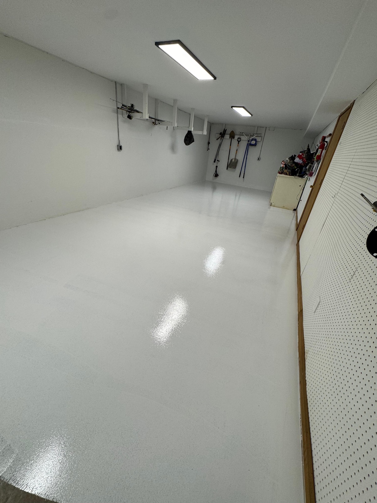High-gloss white epoxy coat on a garage floor in Greensboro NC