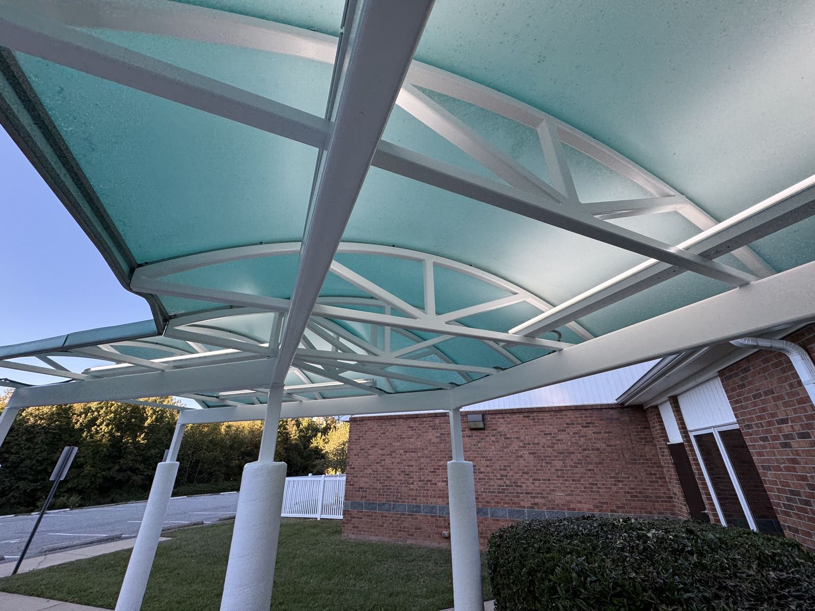 Freshly painted white frame of a covered walkway canopy at a daycare center in Greensboro NC
