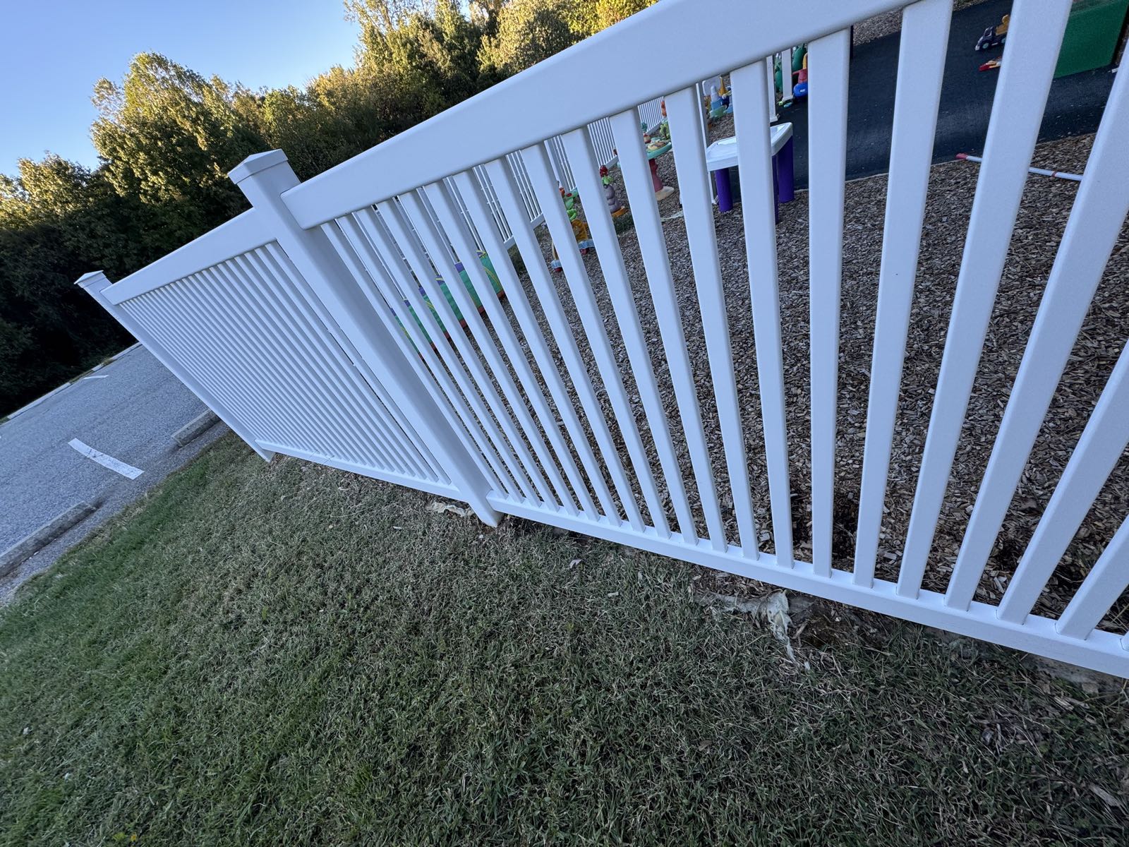 Clean white vinyl daycare fence after soft washing removed the mold in Greensboro NC