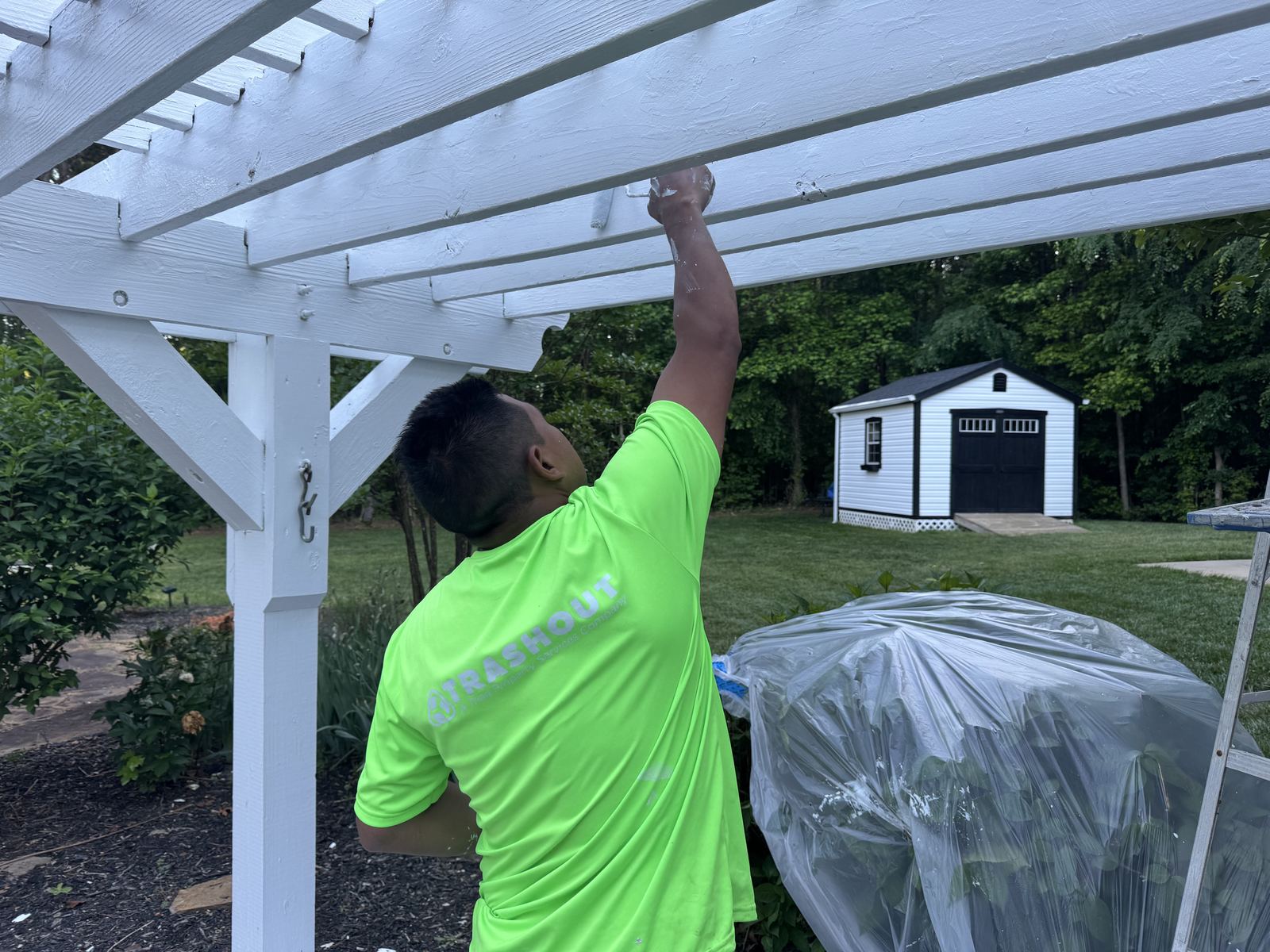 TrashOut exterior painting on a white pergola in Greensboro NC