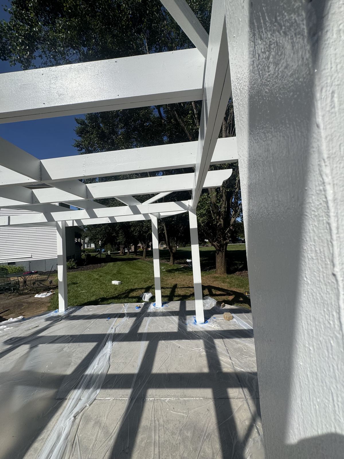Exterior painting prep with protected patio surfaces