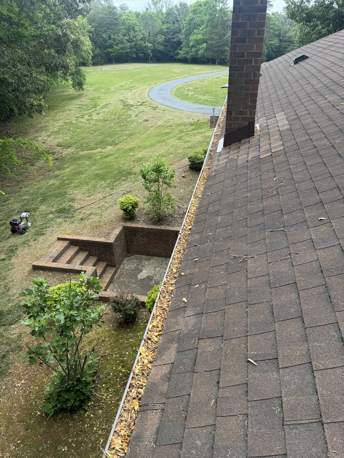 Gutter full of leaves before cleaning in Greensboro NC