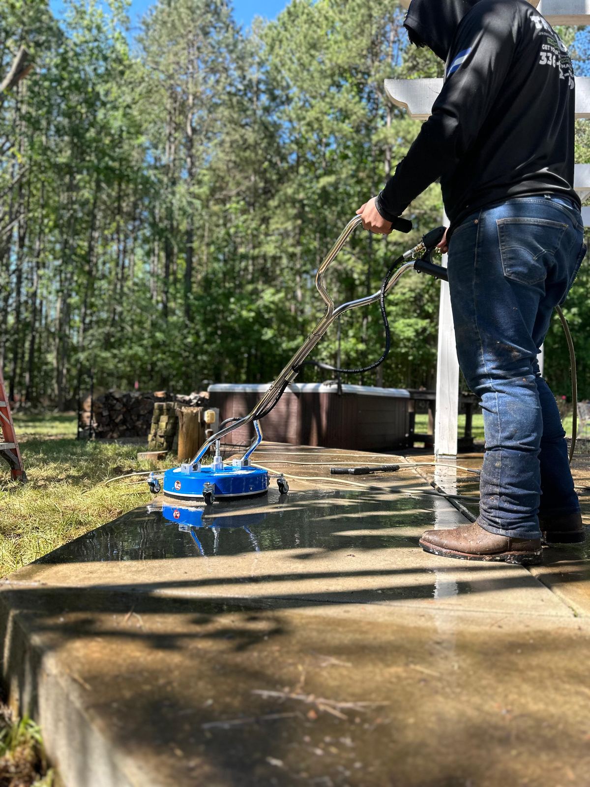 TrashOut pressure washing concrete with a surface cleaner